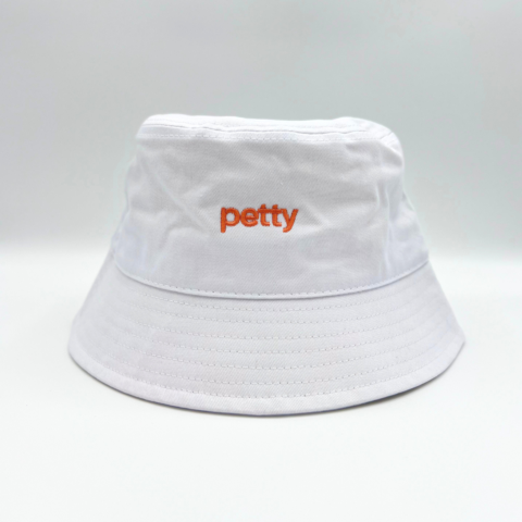 white bucket hat with word petty in peach color